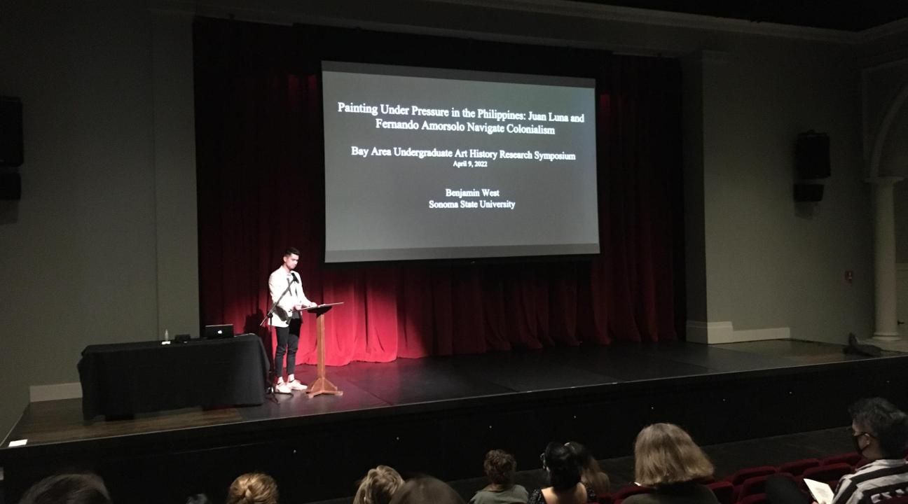 student presenting on stage