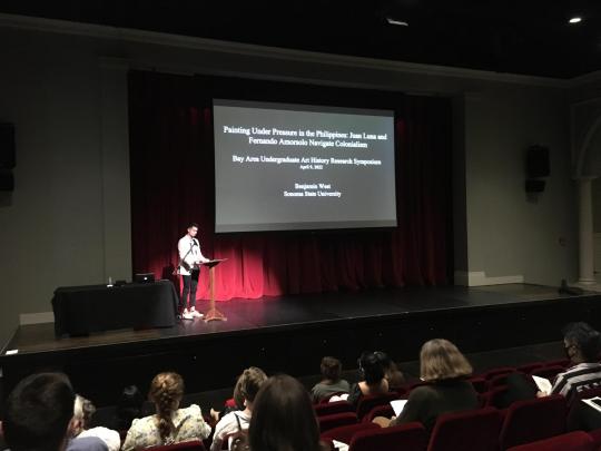 student presenting on stage